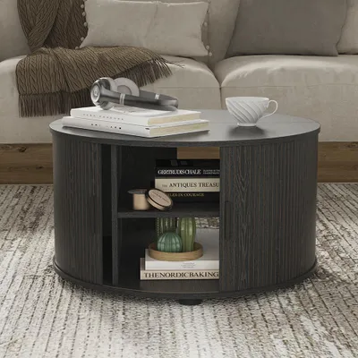 A round coffee table with storage is placed in a living room setting, next to a sofa.