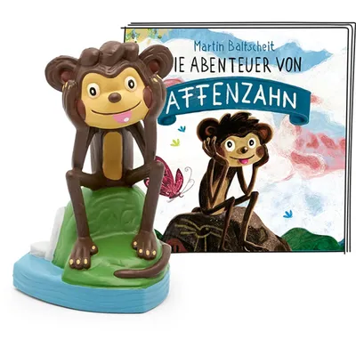 A toy monkey figure and a book cover featuring monkeys.