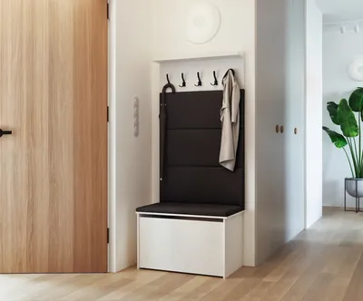 An entryway with a wooden door, a shoe bench with a coat rack, and a plant.