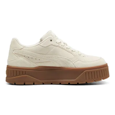 A side view of a single beige Puma sneaker with a brown sole, isolated on a white background.