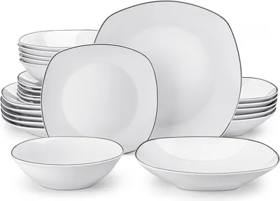 A set of white ceramic dishes with a thin black rim, neatly arranged.