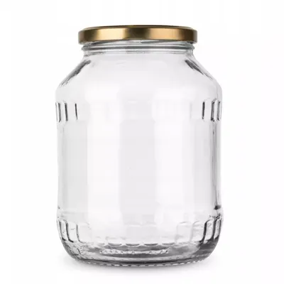 A clear glass jar with a gold lid, presented on a white background.