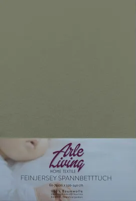 A close-up of a baby's face and a product label for a baby bedsheet.