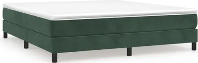 A dark green upholstered bed frame with a white mattress on top.