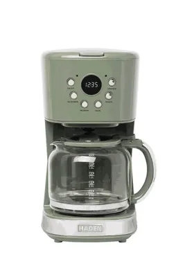 A green coffee maker with a glass carafe on a white background.