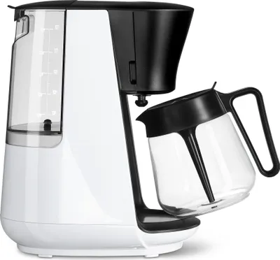 A white and black Tchibo filter coffee machine with its glass carafe tilted out.