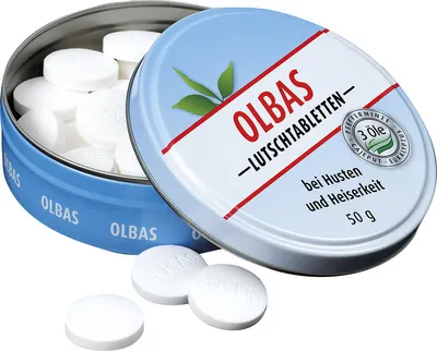 A tin of Olbas lozenges with some lozenges scattered in front.