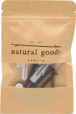 A brown paper bag with a clear window showing black and white hardware items.