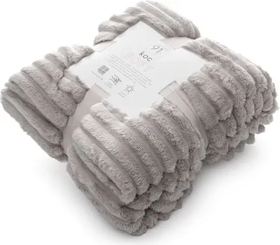 A folded grey blanket with a label attached.