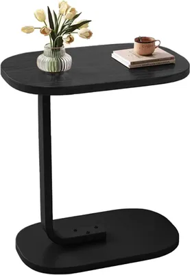 A black side table with a vase of flowers and a cup of coffee on it.