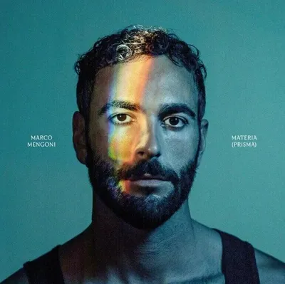 Close-up portrait of a man with a rainbow prism effect across his face.
