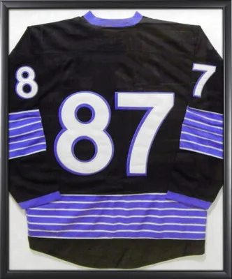The back of a framed hockey jersey with the number 87.