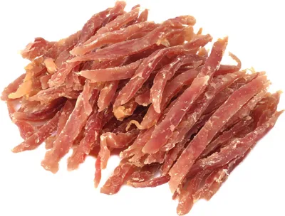 A pile of dried duck jerky strips for dogs, presented on a white background.
