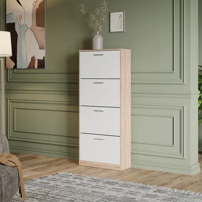 A shoe cabinet with four drawers is placed in a room with green walls and a wooden floor.