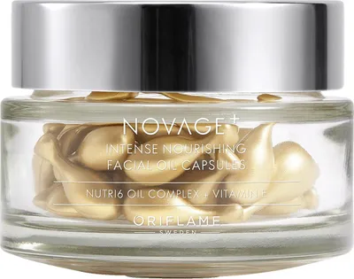A glass jar filled with golden facial oil capsules, with the brand name and product details printed on the front.