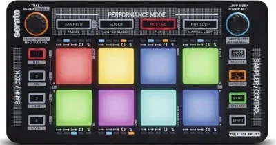 A top-down view of a black DJ controller with illuminated pads.