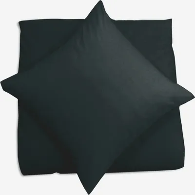 A dark pillowcase is folded and placed on top of another pillowcase, both on a white background.