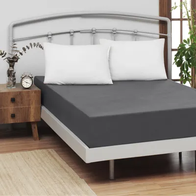A bed with a fitted sheet and two pillows.