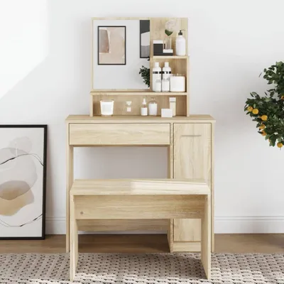 A vanity table with a mirror and stool, decorated with various cosmetic bottles and a small plant. A framed artwork is visible on the left, and a potted plant with fruit is on the right.