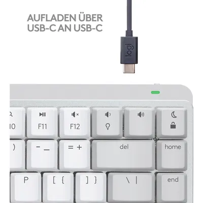 A close-up view of a white keyboard with a USB-C cable and connector.