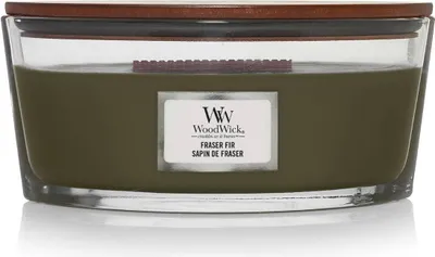 A close-up studio shot of a large, green scented candle in a clear glass jar with a wooden lid.