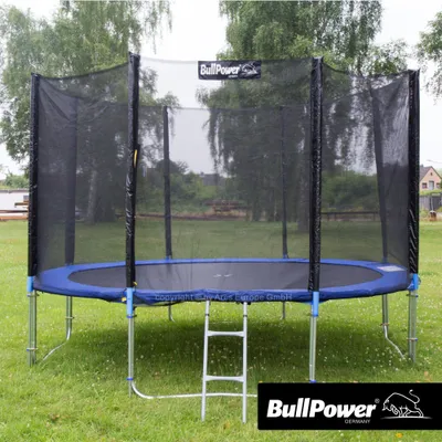 A trampoline set up outdoors on a grassy lawn.