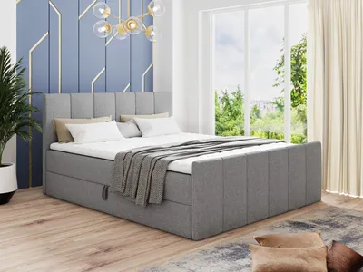 A bedroom scene with a bed, window, and plant.