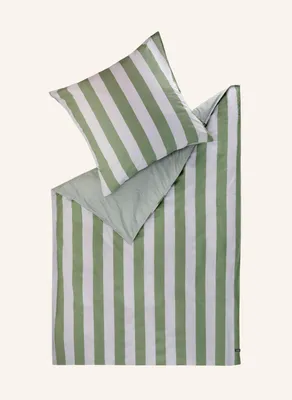 A folded duvet cover and pillowcase with green and white stripes, laid out on a light gray background.