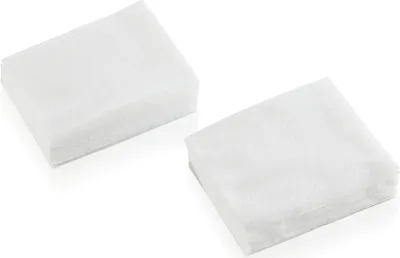 Two stacks of white disposable cloths are shown against a white background.