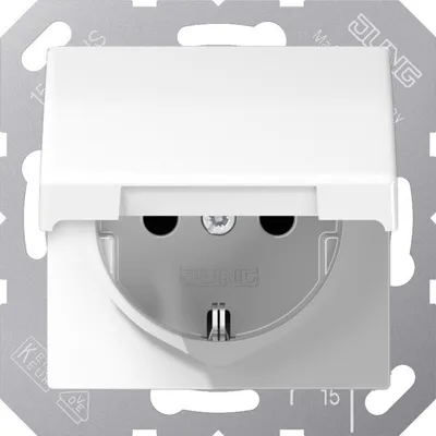A close-up view of a white electrical outlet with a flip cover, mounted on a metallic plate.