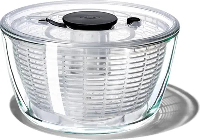 A clear studio shot of a glass salad spinner.