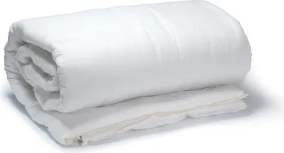 A white weighted blanket is rolled up and placed on a white surface.