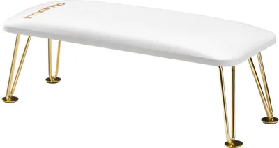 A white manicure mat with gold legs.