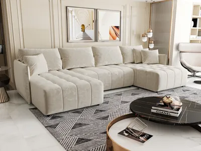 A modern living room with a large U-shaped sofa, coffee tables, and artwork on the wall.