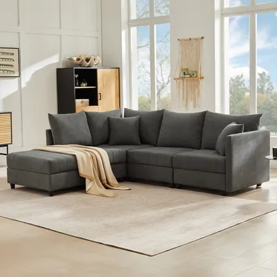 A modern living room with a large sectional sofa and a rug.