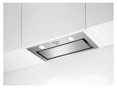 A built-in kitchen range hood mounted under white cabinets.