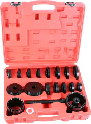 A tool kit with various metal components laid out in a red plastic case.