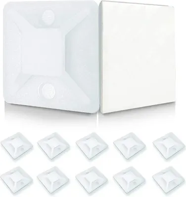 A top-down view of multiple white cable tie mounts, with two larger examples in the background.