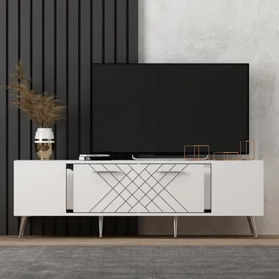 A modern white TV stand with a large black TV on top, set against a dark slatted wall and a textured concrete wall.