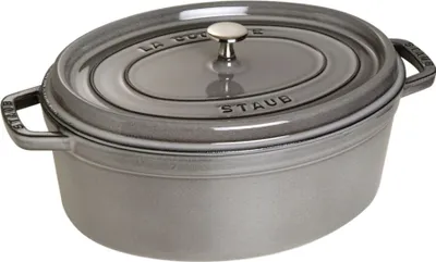 A gray oval Staub cocotte pot with a lid, shown from a slightly elevated side angle against a white background.