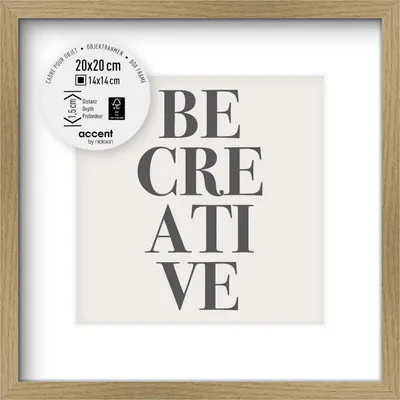 A framed picture with the words "BE CREATIVE" printed on a light background, set within a wooden frame.
