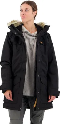 A woman wearing a black parka with a grey hoodie underneath, standing against a white background.