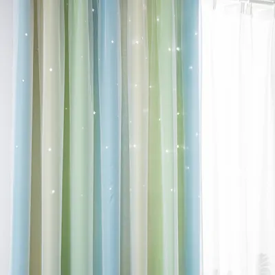 A close-up view of sheer curtains with a gradient of green, blue, and beige colors, featuring small white star-like embellishments.