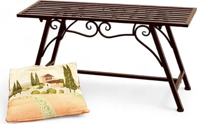 A brown metal garden bench with a decorative pillow in front of it, set against a white background.