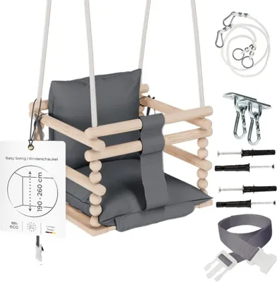 A baby swing set with all its accessories laid out next to it on a white background.