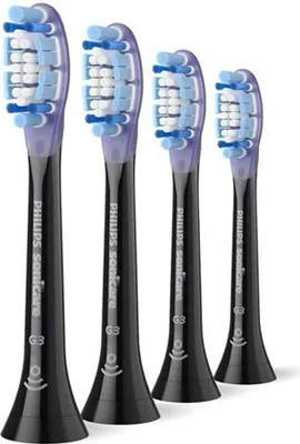 Four black toothbrush heads with purple accents and blue and white bristles are arranged diagonally on a white background.