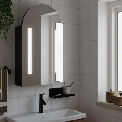 A bathroom sink area with a mirrored cabinet above it.