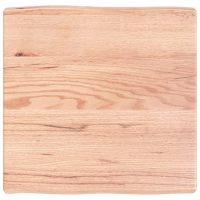 A close-up view of a wooden tabletop with visible grain patterns.