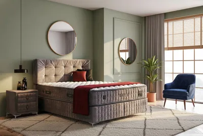 A bedroom scene featuring a bed, nightstand, and armchair.