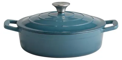 A teal cast iron pot with a silver lid handle, shown from a slightly elevated side angle against a white background.